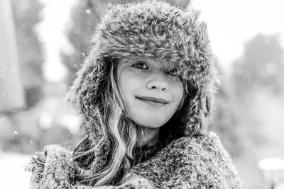 Portrait of smiling girl wearing fur hat during winter