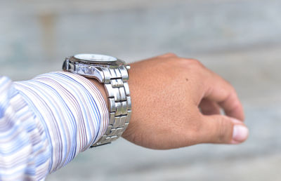 Close-up of man hand on metallic wall