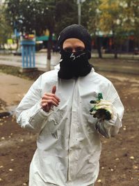 Portrait of young man in warm clothing standing at park