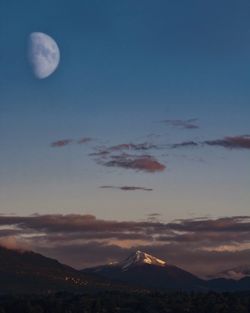 Scenic view of snowcapped mountains against sky at night