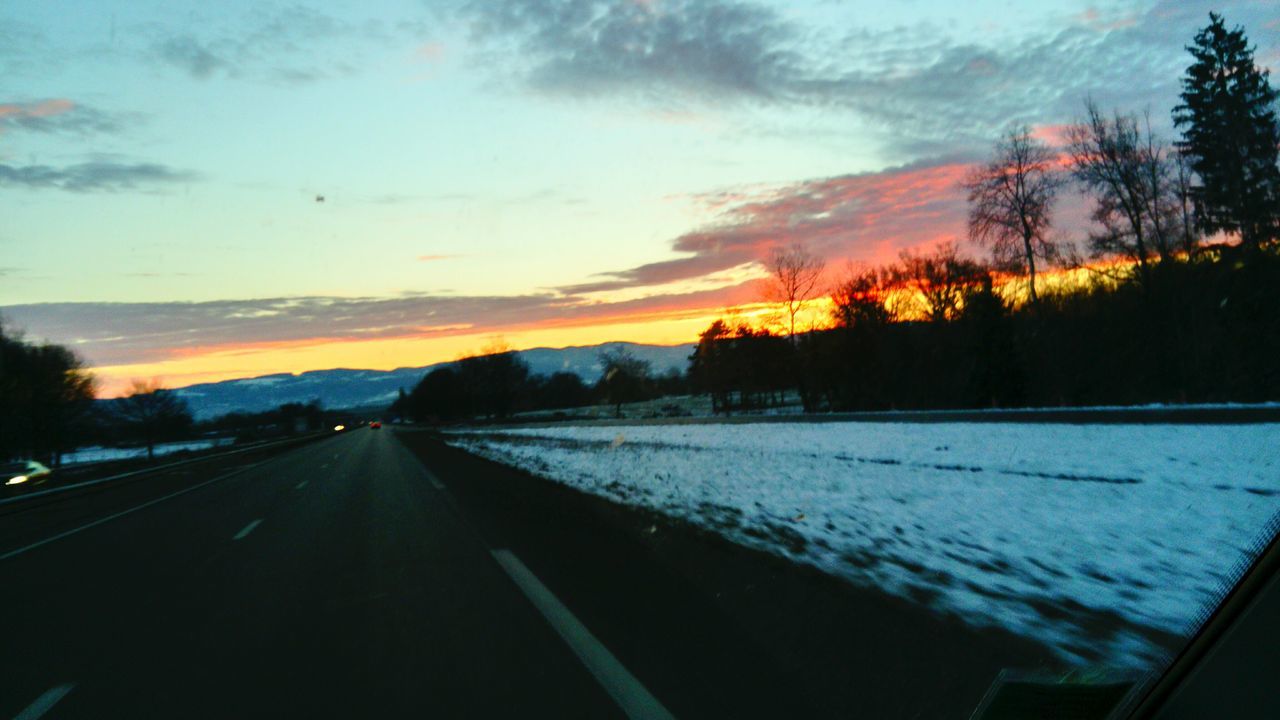 road, sky, the way forward, transportation, sunset, tree, nature, car, no people, beauty in nature, cloud - sky, landscape, land vehicle, outdoors, scenics, cold temperature, day