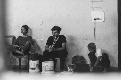 Group of people sitting on wall