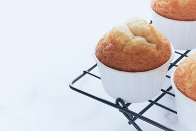 Close up of cooling rack with muffins. copy space on white background