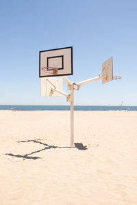 Basketball court in the middle of the beach in a sunny day