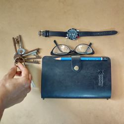 Close-up of hand holding eyeglasses on table