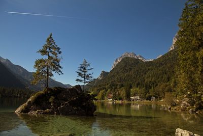 Scenic view of lake and mountains against clear sky