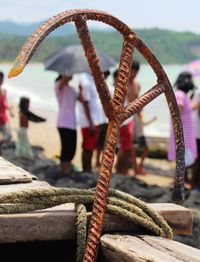 Close-up of rusty anchor at beach