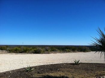 Scenic view of desert against clear blue sky