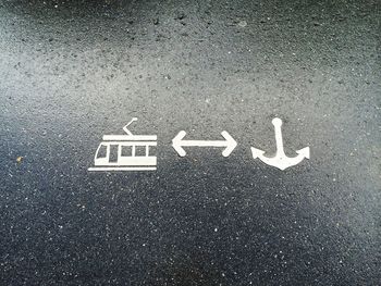 High angle view of arrow sign on road