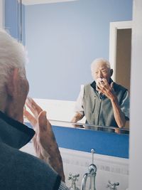 Senior man looking in the mirror