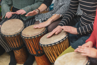 Midsection of man playing drum