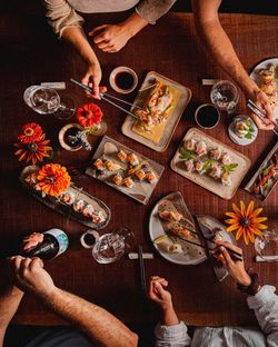 Cropped hands of woman preparing food on table