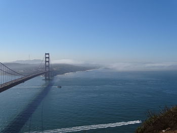 View of suspension bridge over sea