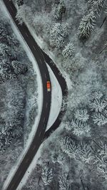 High angle view of vehicle on road amidst forest during winter