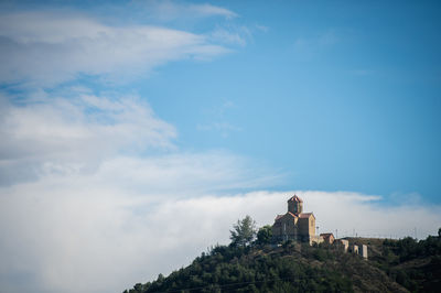 Narikala fort on hill against blue sky