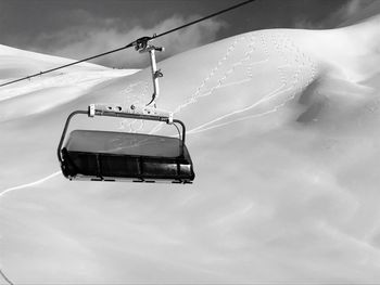 Low angle view of overhead cable car against sky