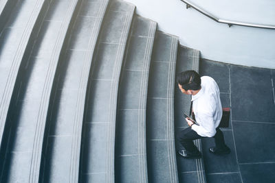 High angle view of businessman climbing on steps