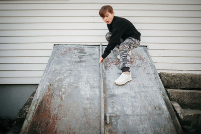 Side view of man standing on staircase