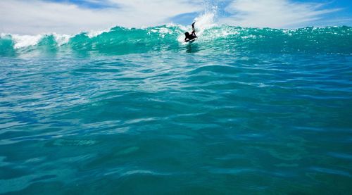 Silhouette man surfing in sea