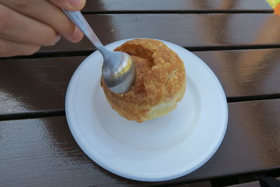 Cropped image of person holding ice cream in plate