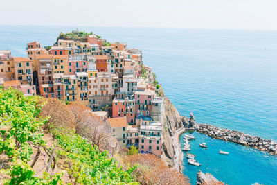 High angle view of townscape by sea against sky