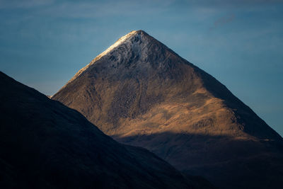 Low angle view of pyramid shaped mountain against sky