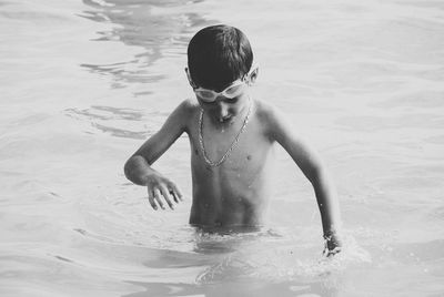 Boy swimming in sea at beach