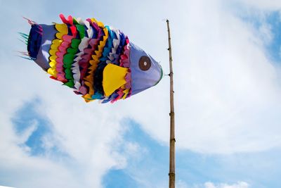 Low angle view of balloons against sky