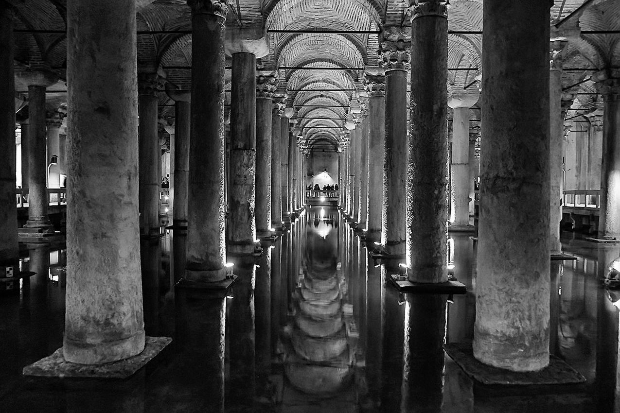 in a row, architecture, built structure, architectural column, indoors, building exterior, metal, transportation, day, incidental people, column, no people, diminishing perspective, building, city, repetition, empty, side by side, tree