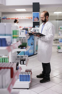 Portrait of female doctor examining chemical in laboratory