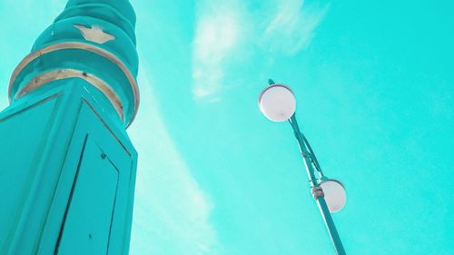 Low angle view of street light against blue sky