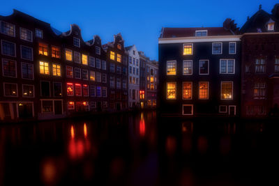 Reflection of illuminated buildings in city at night