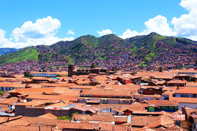 Townscape by mountains against sky