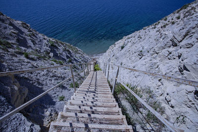 High angle view of steps leading towards sea