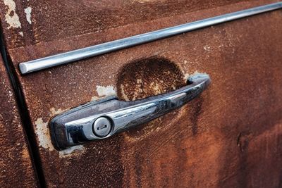 Close-up of old abandoned car door handle