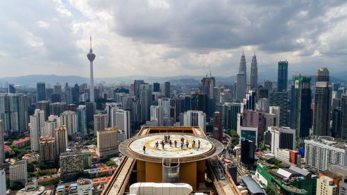 High angle view of cityscape against cloudy sky