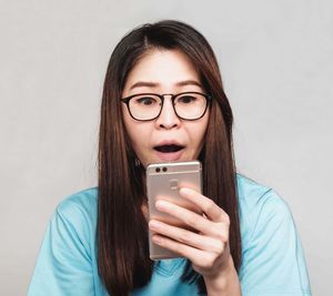 Portrait of young woman using mobile phone