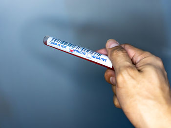 Close-up of a hand holding paper