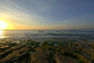 Scenic view of sea against sky at sunset