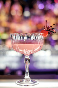 Close-up of pink squirrel cocktail on bar counter