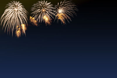 Low angle view of firework display at night