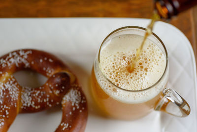 Close-up of beer and pretzel on table