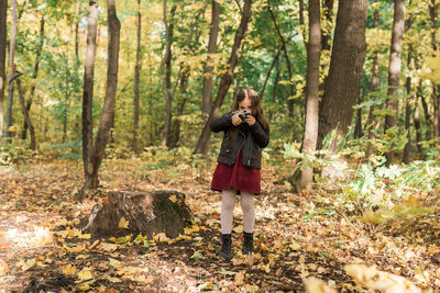 Full length of a man standing in forest