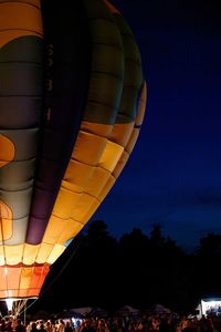 Low angle view of hot air balloons against sky at night