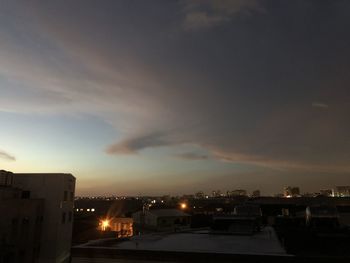 High angle view of illuminated buildings against sky at sunset