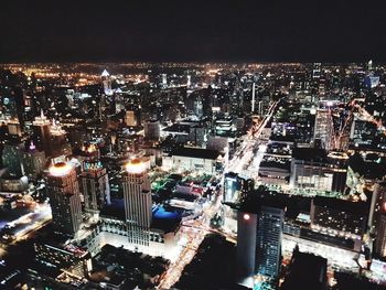 Aerial view of city lit up at night