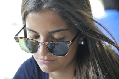 Close-up portrait of young woman wearing sunglasses