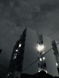 Low angle view of illuminated building against sky at night