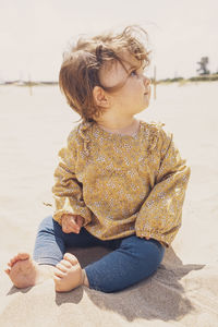 Full length of baby boy sitting on beach