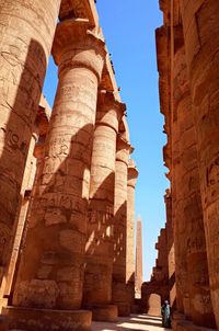 Woman standing by old ruin in city